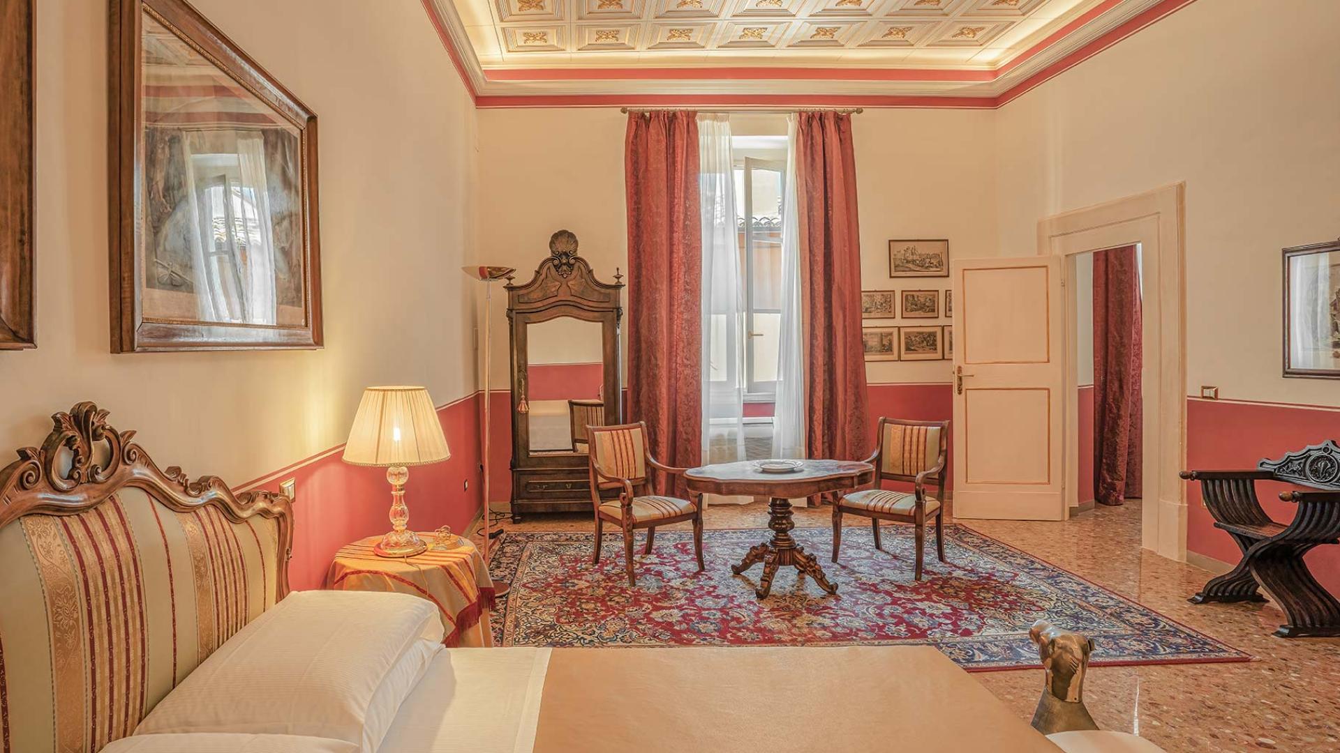 Elegante camera d'albergo con mobili antichi e decorazioni classiche.